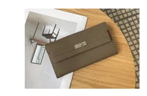 Detail view of premium cowhide leather long wallet for women in elegant taupe with metal lock.