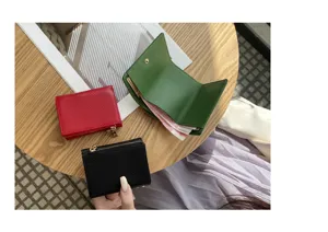 Compact leather trifold wallet detail showing multiple card slots and coin pocket design.