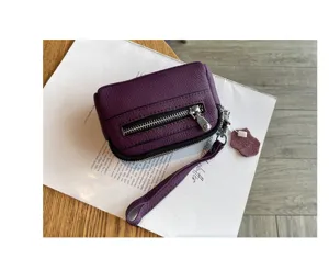 Purple genuine leather mini coin purse with wrist strap and zipper pocket for women.
