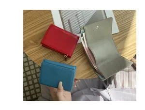Mini trifold leather wallet for women with coin pocket and card slots, compact design.