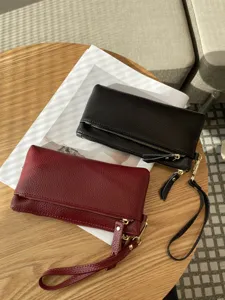 Genuine leather clutch bag for women, long large capacity wallet with wrist strap main view.