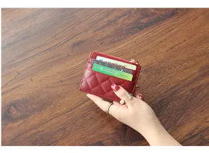 Red quilted leather card holder detail shot, compact minimalist zipper wallet for women.