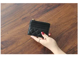Detailed view of black quilted leather card holder wallet with zipper and card slots for women.