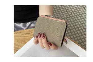 Detail view of genuine cowhide leather compact card wallet with elegant contrast color stitching.