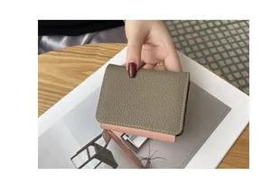 Compact genuine leather card holder for women, slim bifold multi-slot wallet detail.