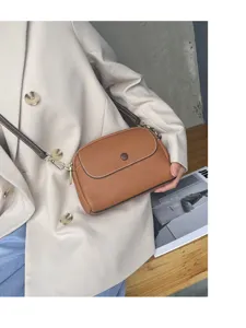 Brown leather crossbody bag for women, stylish minimalist shoulder bag with adjustable strap.