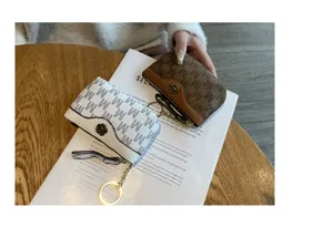 Mini coin purse for women, chic design short wallet with cute floral button and zipper keychain.