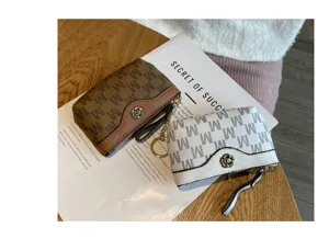 Detailed view of cute mini coin purses with M monogram pattern, zipper and flower snap.