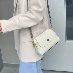 Stylish white leather crossbody bag for women, featuring a chic flap and shoulder strap.