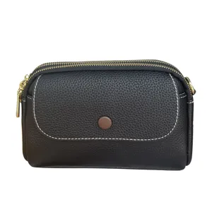 Women genuine leather black crossbody shoulder bag with double zipper and stylish design.