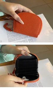 Orange leather accordion card holder detail, compact zipper coin purse with multiple card slots.
