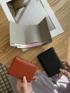 Compact genuine leather trifold women wallet with RFID blocking and spacious coin pocket.