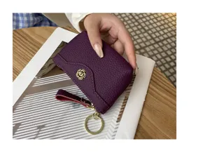 Purple leather coin purse detail, chic mini card holder with wrist strap and gold key ring.