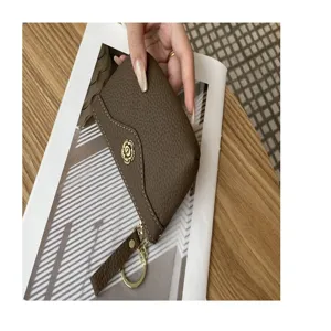 Genuine leather coin purse for women, brown leather card holder with chic flower metal decor.