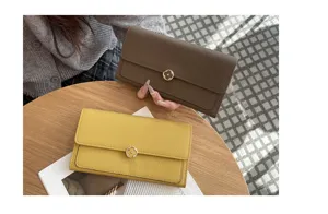 Detailed view of genuine leather women's long wallet with elegant floral metal clasp design.