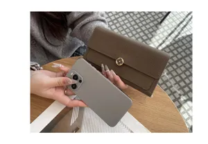 Detailed shot of a genuine leather long wallet in brown with elegant metal flower lock.