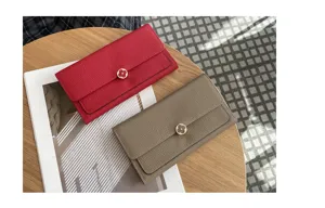 Detailed view of genuine leather long wallet with elegant clover metal clasp design.