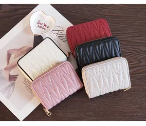 Detailed shot of multi-color quilted small zip wallets, elegant leather card holder texture.