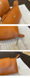 Mini brown leather coin purse pendant, compact zipper wallet with keychain for daily use.