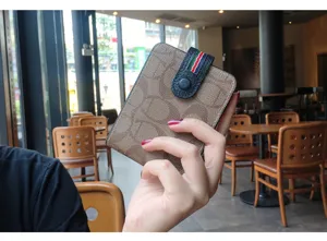 Brown monogram leather driver license holder card wallet with snap closure and strap.