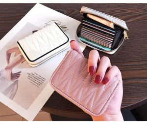 Compact leather card holder for women with multiple card slots and secure zipper closure.