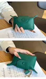 Mini green leather coin purse with keychain and zipper closure, compact design for daily use.