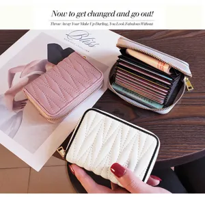 Compact genuine leather card holder with multi-card slots and secure zipper closure.