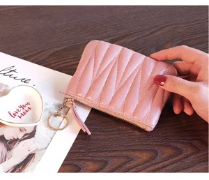 Pink quilted leather coin purse with zipper and keyring, compact minimalist wallet for women.