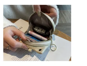 Detailed view of the compact genuine leather coin purse showing interior card and key storage capacity.
