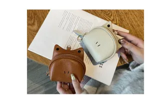 Detailed view of cute cat shaped leather coin purse with secure zipper and mini keychain ring.