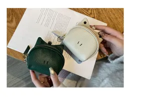 Detailed close-up view of cute leather coin purse featuring animal shape and metal zipper.