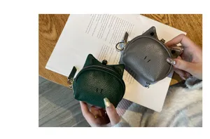 Genuine leather cat ear coin purse detail view, cute mini zipper wallet with keyring pendant.