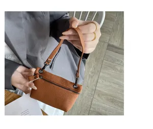 Genuine leather mini coin purse detail view showing soft cowhide texture and zipper.