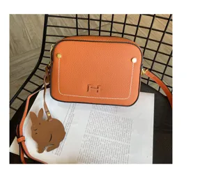 Genuine leather crossbody bag for women, fashion camera bag with rabbit charm and strap.