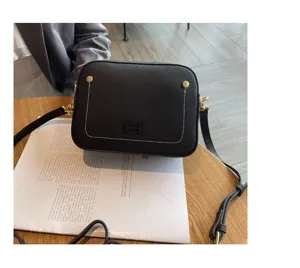 Genuine leather women shoulder bag trendy black camera bag with gold hardware and stylish design.