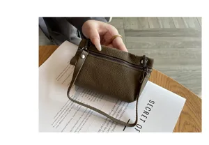 Genuine leather mini coin purse for women, soft cowhide zipper pouch with strap, compact design.