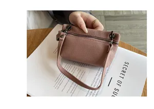Genuine leather mini coin purse for women, soft small handbag with zipper and handle.