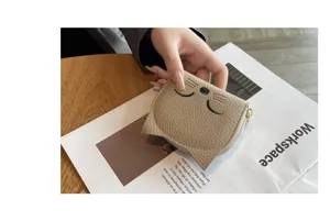 Detailed close-up of cute cat shaped genuine leather card holder, compact and stylish daily accessory.