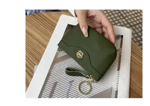 Green genuine leather coin purse detail shot, featuring metal flower snap and keyring wrist strap.