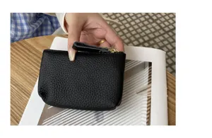 Genuine leather coin purse for women, stylish black mini wallet with zipper and card holder.