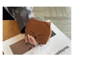 Close-up detail shot of cute brown leather cat shaped coin purse and card holder design.