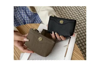 Genuine leather coin purse and card holder with elegant floral snap closure in detail view.
