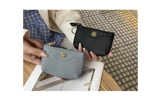 Detail shot of genuine leather coin purse with metal flower snap and zipper close.