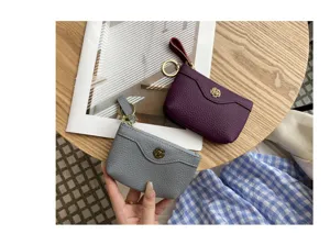 Genuine leather coin purse and card holder with stylish flower metal decor for women daily use.