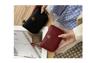 Compact leather coin purse with metal flower clasp, stylish mini wallet for women and girls.