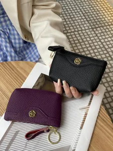 Fashion genuine leather coin purse for women, stylish small change bag with metal flower clasp.