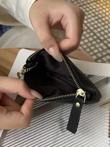 Black genuine leather coin purse with metal zipper, compact card holder for women everyday use.