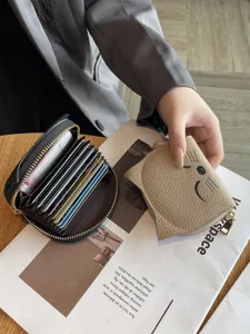 Compact multi-slot accordion card wallet with cute cat embroidery and zipper design.