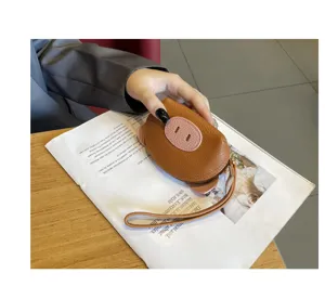 Mini genuine leather coin purse for women, cute pig design with wrist strap, trendy detail view.