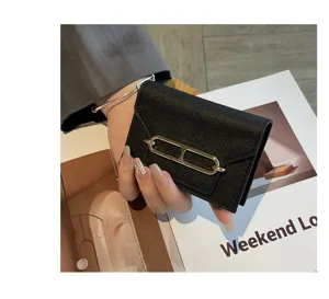 Black genuine leather card holder for women with stylish metal hardware, premium mini wallet.